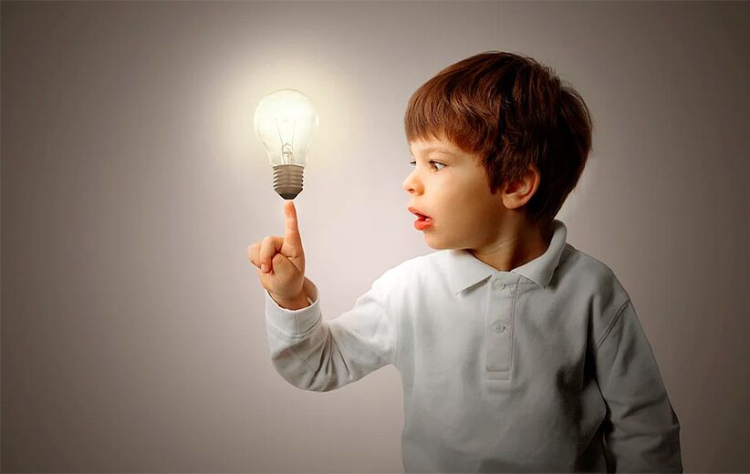 Boy with incandescent light bulb